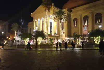 a group of people standing in front of a building at night at Casa del Cioccolato in Palermo