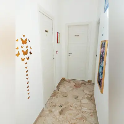 a hallway with two white doors and a tile floor at B&B D'Amico87 in Bagheria