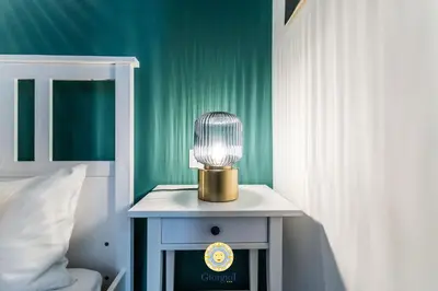 a lamp on a night stand next to a bed at Giorgio I rooms in Palermo