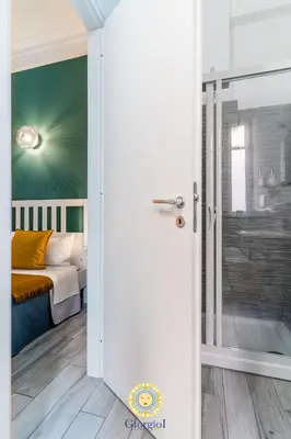 a bedroom with a bed and a sliding glass door at Giorgio I rooms in Palermo
