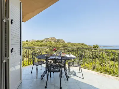 a patio with a table and chairs on a balcony at Apartment Cicladi Tinos by Interhome in Santa Flavia