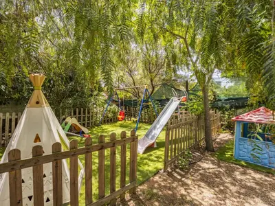 a playground with a slide and a swing set at Apartment Cicladi Milos by Interhome in Santa Flavia