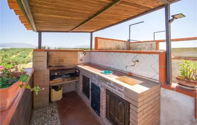 an outdoor kitchen with a counter and a sink at Beautiful Home In Partinico Pa in Balestrate