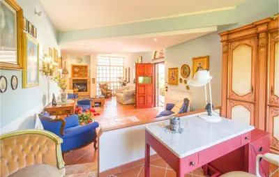 a living room with a table and blue chairs at Beautiful Home In Partinico Pa in Balestrate