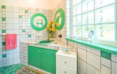 a bathroom with a green sink and mirrors at Beautiful Home In Partinico Pa in Balestrate