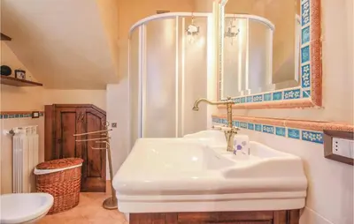 a bathroom with a white sink and a mirror at Villa Tourig Beach in Mandra Capreria