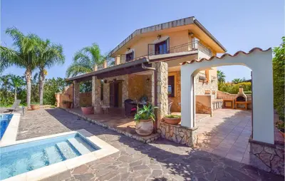 an external view of a house with a swimming pool at Villa Tourig Beach in Mandra Capreria