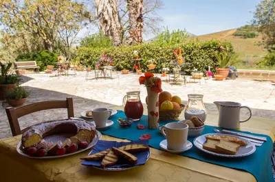 a table with bread and other food on it at Agriturismo Tarantola in Alcamo