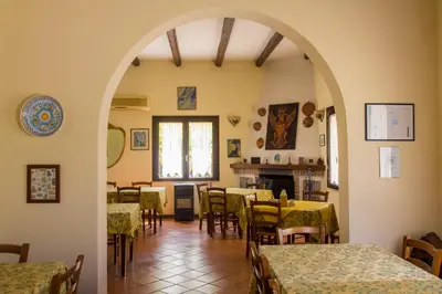 an archway in a restaurant with tables and chairs at Agriturismo Tarantola in Alcamo