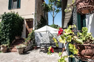 a patio with a table and an umbrella at Ciuri Ciuri Mondello in Mondello