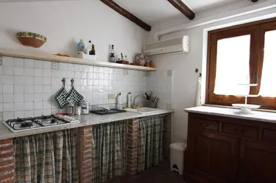 a kitchen with a stove and a sink and a window at Ciuri Ciuri Mondello in Mondello