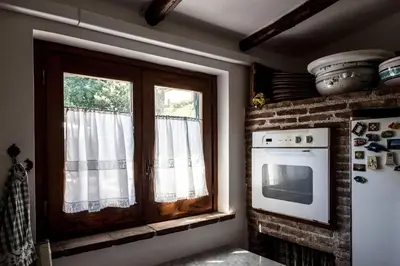 a kitchen with a window and a stove and a microwave at Ciuri Ciuri Mondello in Mondello