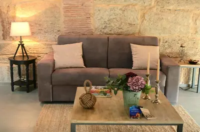 a living room with a couch and a coffee table at La Suite del Principe con parcheggio incluso in Palermo
