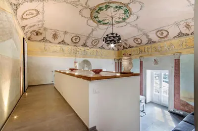 a kitchen with a bar in a room with a ceiling at La Suite del Principe con parcheggio incluso in Palermo