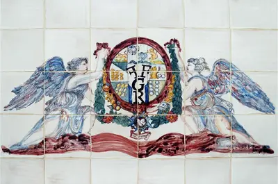a tile wall with two angels holding a shield at La Suite del Principe con parcheggio incluso in Palermo