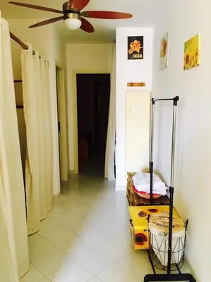 a living room with a ceiling fan and a cart at Appartamento Girasole in San Vito lo Capo