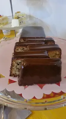 three pieces of chocolate cake on a plate on a table at B&B L'Officina di Apollo in Mondello