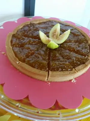 a chocolate cake with apples on top on a pink plate at B&B L'Officina di Apollo in Mondello