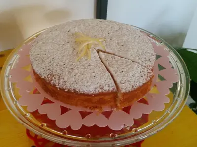 a cake on a glass plate on a table at B&B L'Officina di Apollo in Mondello