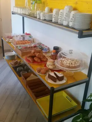 a shelf filled with lots of different types of food at B&B L'Officina di Apollo in Mondello
