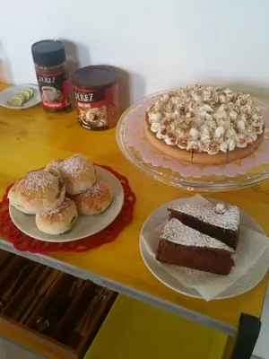 a table with two plates of cake and donuts at B&B L'Officina di Apollo in Mondello