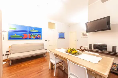 a dining room with a table and a couch at Rabbad Apartments in Palermo