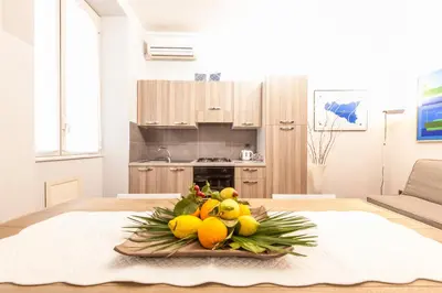 a bowl of fruit on a table in a kitchen at Rabbad Apartments in Palermo