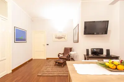 a living room with a flat screen tv on the wall at Rabbad Apartments in Palermo