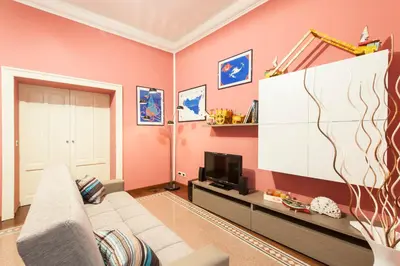a living room with a couch and a tv at Rabbad Apartments in Palermo