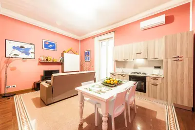 a kitchen and living room with a table with fruit on it at Rabbad Apartments in Palermo