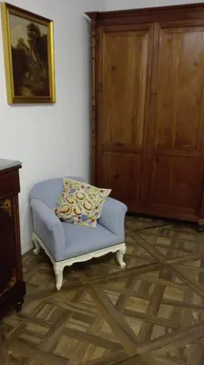 a blue couch with a pillow in a room at Demetra Rooms in Palermo