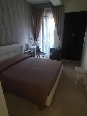 a bedroom with a large bed and a table and chairs at Ruggero Settimo Gallery in Palermo
