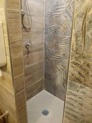 a shower with a glass door in a bathroom at Ruggero Settimo Gallery in Palermo