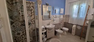 a bathroom with a sink and a toilet and a shower at A Casa Di Lilly in Palermo