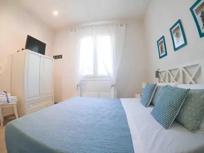 a bedroom with a large bed and a window at Villa Almyra in San Vito lo Capo