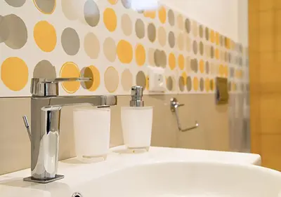 a bathroom with a sink with two cups on it at Villa Almyra in San Vito lo Capo