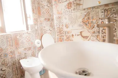 a bathroom with a white sink and a toilet at Chibedda Dimora Cesca in Castellammare del Golfo