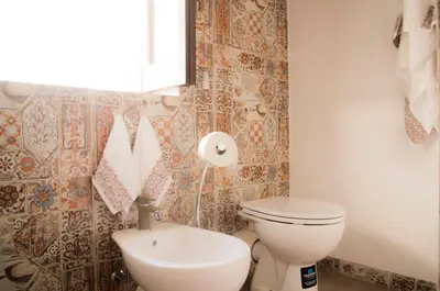 a bathroom with a toilet and a sink at Chibedda Dimora Cesca in Castellammare del Golfo