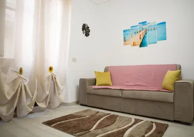a living room with a couch and a rug at Light Blue in Balestrate