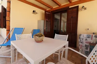 a bedroom with a bed with two towels on it at casa Vincenzo in Castelluzzo