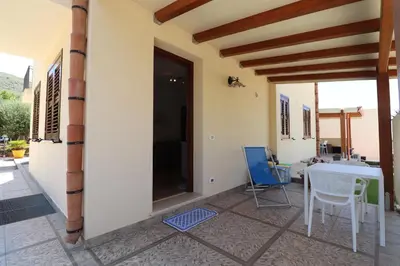 a bedroom with two beds and a dresser and a window at casa Vincenzo in Castelluzzo