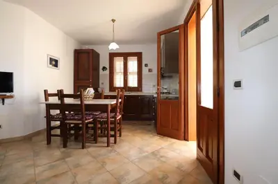 a table with two chairs and a table with a plant on it at casa Vincenzo in Castelluzzo
