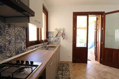 a dining room with blue chairs and a table at casa Vincenzo in Castelluzzo