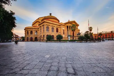 a large building in a plaza in front of a building at Palazzo Planeta in Palermo