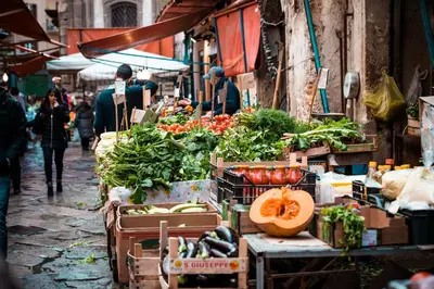 a market with fruits and vegetables on a street at Palazzo Planeta in Palermo
