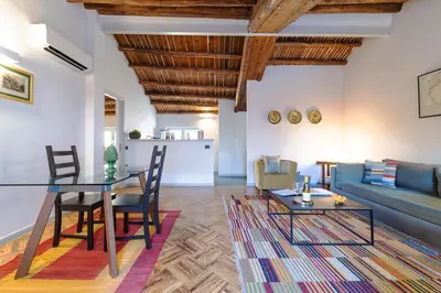 a living room with a table and a couch at Palazzo Planeta in Palermo