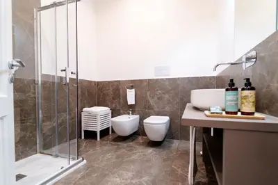 a bathroom with a shower and a toilet and a sink at Palazzo Planeta in Palermo