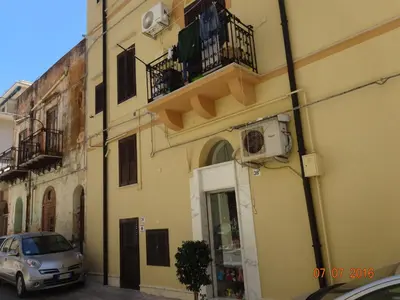 a car parked on a street next to a building at Monolocale La Chicca in Castellammare del Golfo