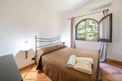 a bedroom with a bed and a window at Villa Eden con piscina a Scopello in Castellammare del Golfo