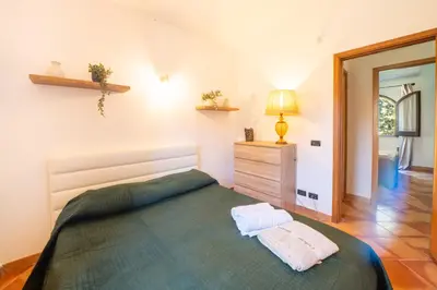 a bedroom with a bed with two towels on it at Villa Eden con piscina a Scopello in Castellammare del Golfo